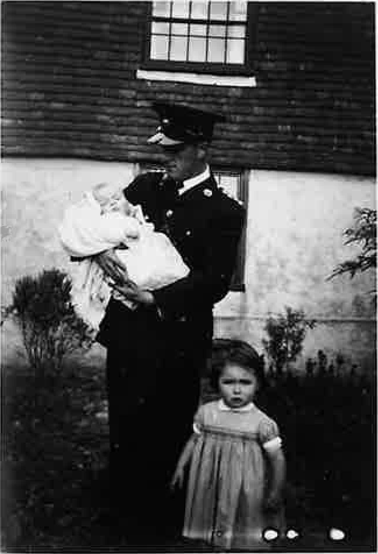 George (Edward Robert) Knight (my grandfather) in Royal Marines Uniform (captain) holding my dad and my Aunt Pam, 1942